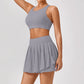 Luxury women’s tennis outfit featuring performance crop top, pleated tennis skirt and lightweight zip jacket, premium courtwear set designed for tennis and active lifestyle