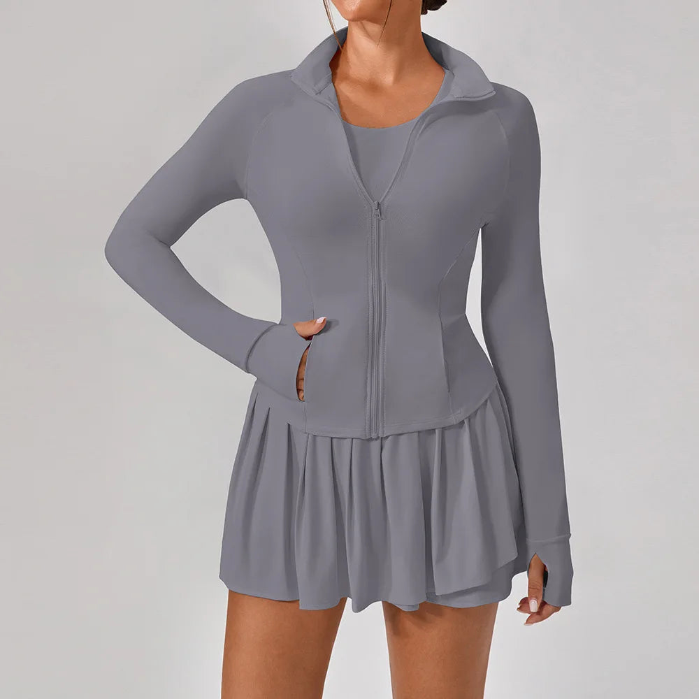 Luxury women’s tennis outfit featuring performance crop top, pleated tennis skirt and lightweight zip jacket, premium courtwear set designed for tennis and active lifestyle