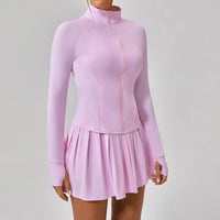 Luxury women’s tennis outfit featuring performance crop top, pleated tennis skirt and lightweight zip jacket, premium courtwear set designed for tennis and active lifestyle