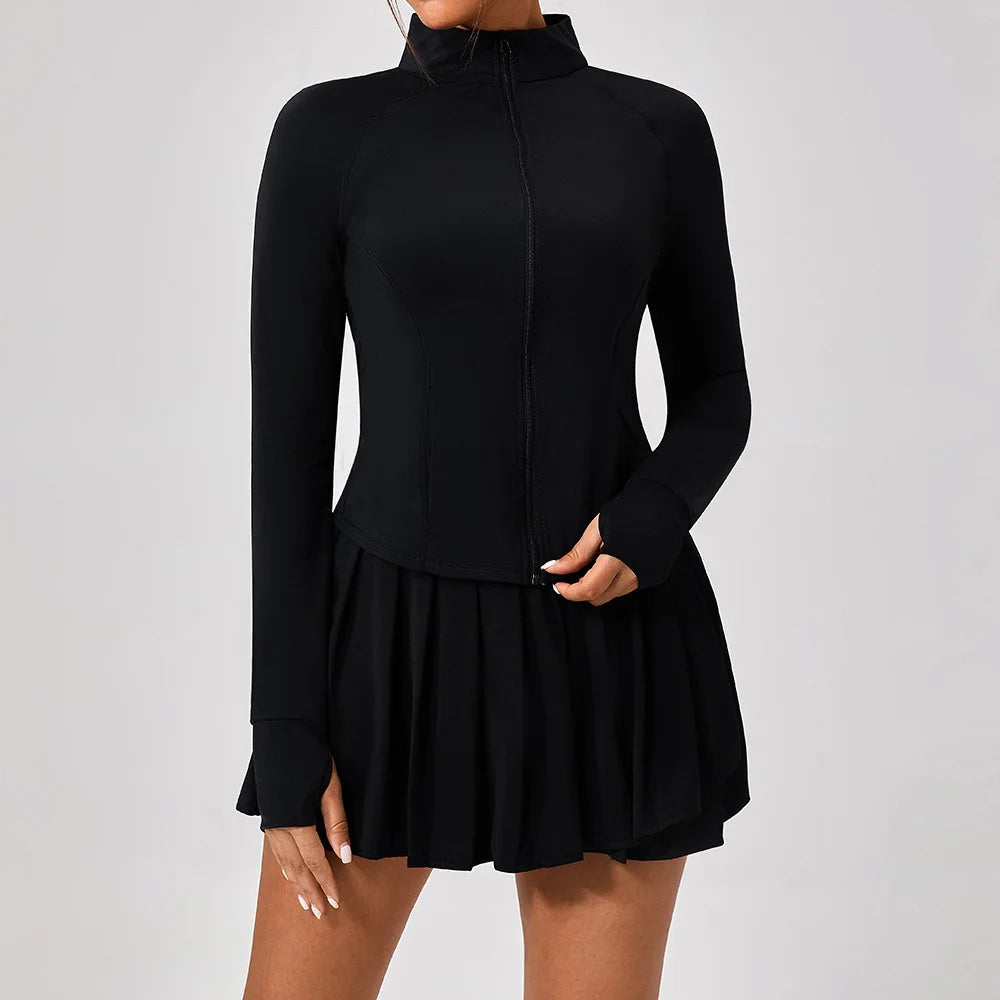 Luxury women’s tennis outfit featuring performance crop top, pleated tennis skirt and lightweight zip jacket, premium courtwear set designed for tennis and active lifestyle
