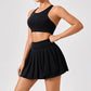 Luxury women’s tennis outfit featuring performance crop top, pleated tennis skirt and lightweight zip jacket, premium courtwear set designed for tennis and active lifestyle