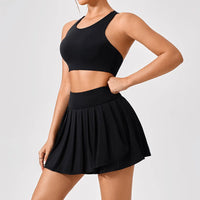 Luxury women’s tennis outfit featuring performance crop top, pleated tennis skirt and lightweight zip jacket, premium courtwear set designed for tennis and active lifestyle