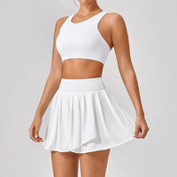Luxury women’s tennis outfit featuring performance crop top, pleated tennis skirt and lightweight zip jacket, premium courtwear set designed for tennis and active lifestyle