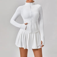 Luxury women’s tennis outfit featuring performance crop top, pleated tennis skirt and lightweight zip jacket, premium courtwear set designed for tennis and active lifestyle