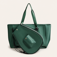 Close-up detail of premium tennis and pickleball shoulder bag with dedicated racket compartment and minimalist athletic styling