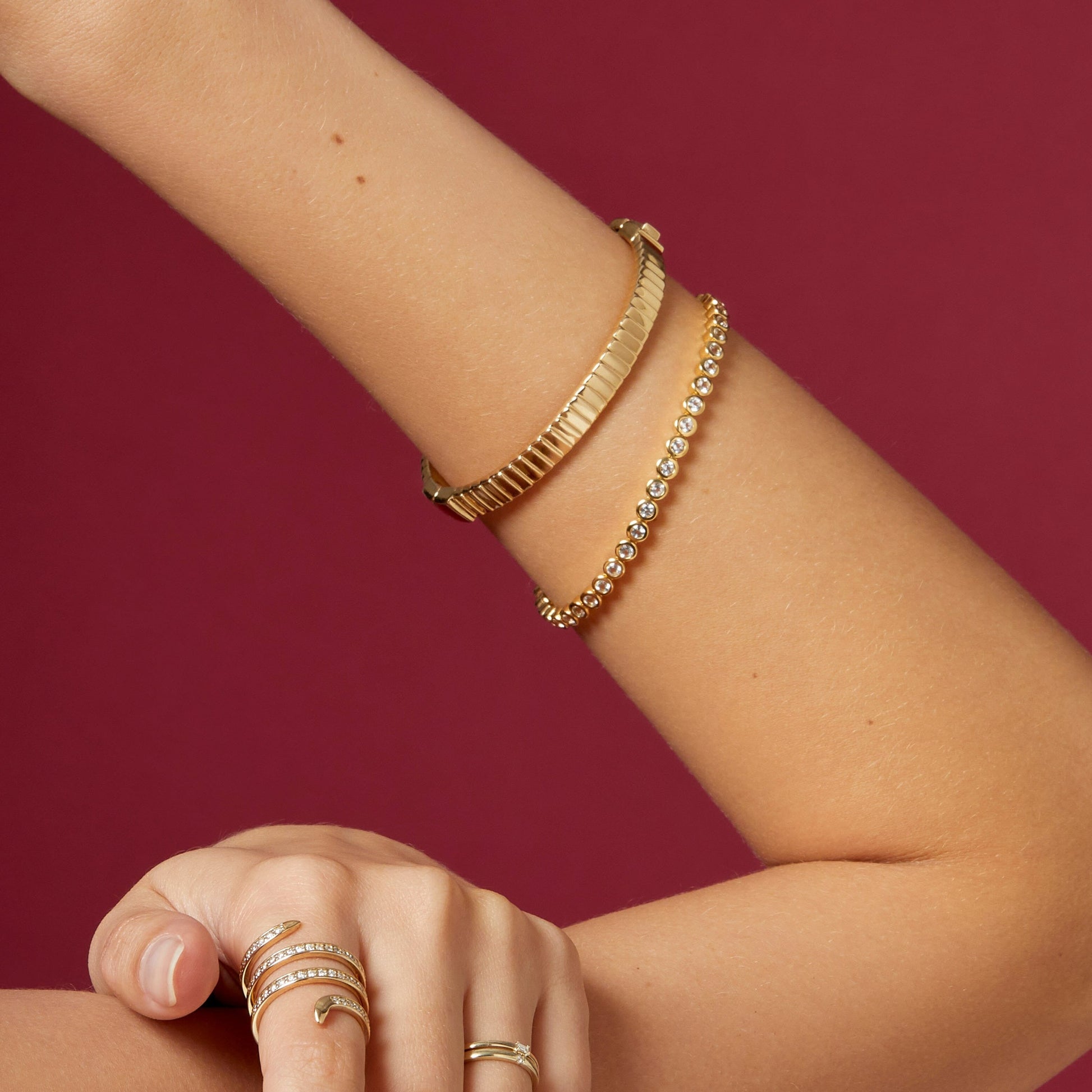 Editorial close-up of premium tennis bracelet with continuous radiant stones and sophisticated lifestyle styling