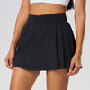 Women's premium tennis skirt styled in an editorial tennis court setting blending luxury sportswear and performance