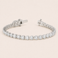 Editorial studio image of elegant white sapphire heart tennis bracelet with radiant minimalist luxury design