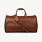 Premium vintage brown leather duffle bag designed for refined travel and elevated lifestyle carry