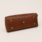 Editorial studio image of premium leather duffle bag featuring structured vintage-inspired travel elegance and spacious storage