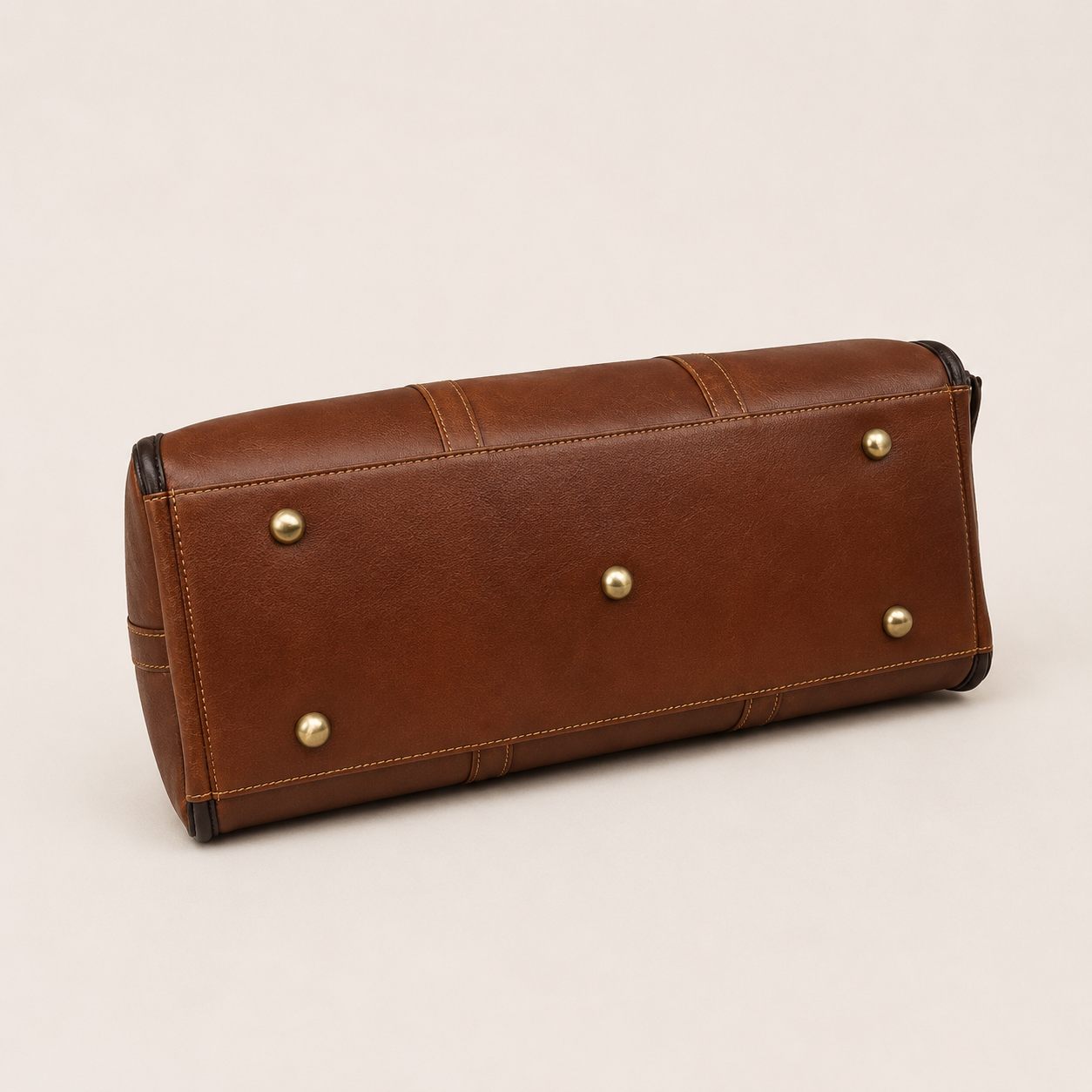 Editorial studio image of premium leather duffle bag featuring structured vintage-inspired travel elegance and spacious storage