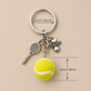 Close-up detail of premium tennis ball keyring with polished metal finish and understated court-inspired everyday style