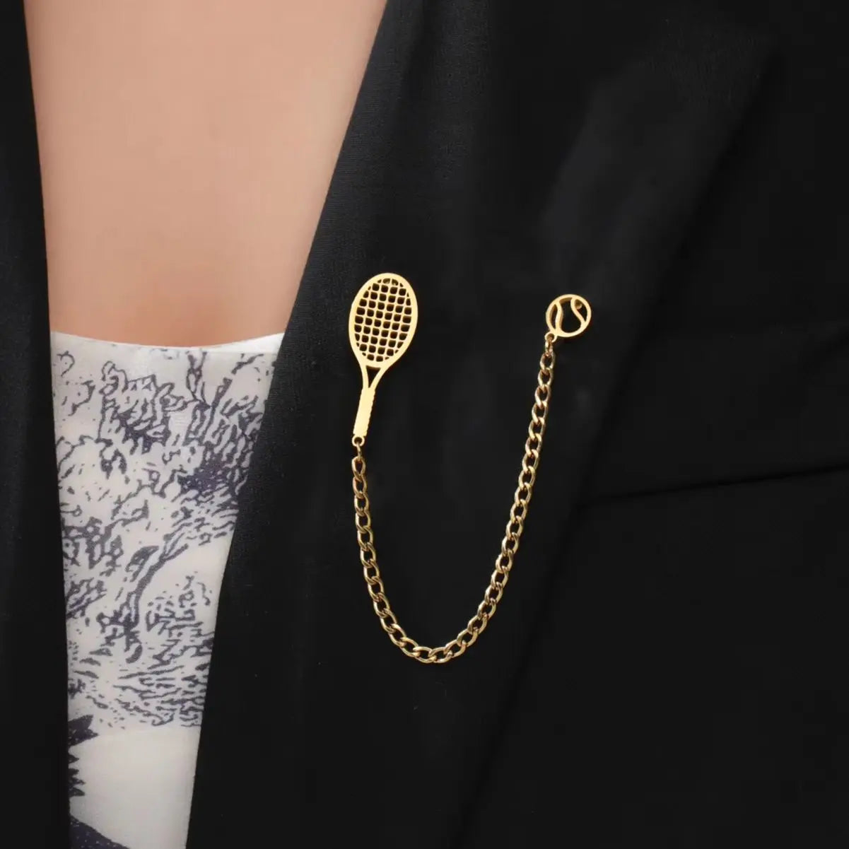 Premium tennis racket and ball lapel accessory designed for refined sport-inspired everyday wear and polished styling