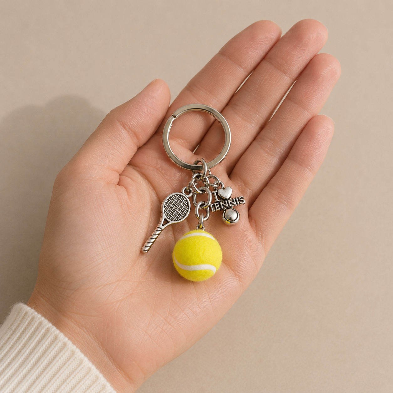 Editorial studio image of premium tennis ball charm keyring featuring refined minimalist accessory design
