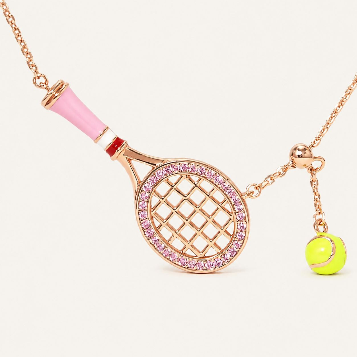 Premium metallic tennis ball keyring displayed in minimalist studio setting with refined sport-inspired aesthetic