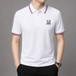 Men's premium knit polo with buttoned collar, streamlined silhouette, and understated sport-lifestyle elegance
