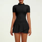 Women's luxury tennis two-piece set featuring structured short sleeve zip top and pleated skirt, blending performance comfort with elevated court style.