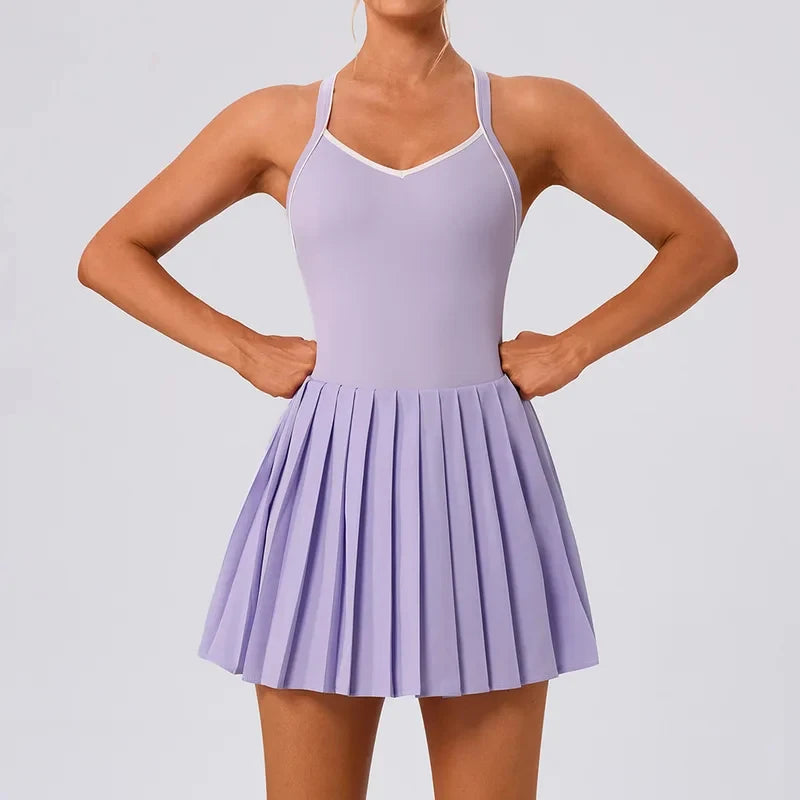 Women's premium pleated tennis dress styled on court with elegant athletic fit and performance fabric