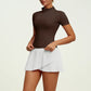 Luxury women's tennis set featuring tailored performance top and pleated athletic skirt, built for fluid motion, polished fit and elevated sporting style.