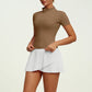 Premium women's pleated tennis set with sculpted fit top and elegant athletic skirt, designed for comfort, versatility and refined movement on and off court.
