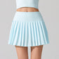 Stylish women’s tennis skirt worn by an athlete standing confidently on a professional tennis court
