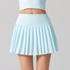 Stylish women’s tennis skirt worn by an athlete standing confidently on a professional tennis court