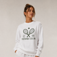 Elegant women's tennis apparel featuring a premium sweatshirt and performance shorts styled for tennis training and off-court lifestyle wear.