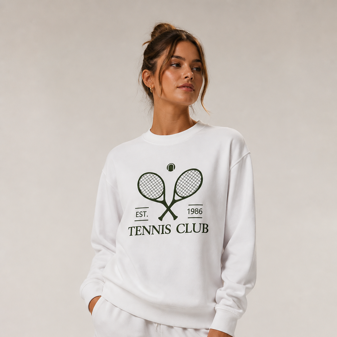 Elegant women's tennis apparel featuring a premium sweatshirt and performance shorts styled for tennis training and off-court lifestyle wear.