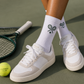 Sophisticated tennis socks worn in a premium sport lifestyle setting with elegant athletic styling