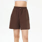 Full-body editorial tennis portrait featuring women’s performance shorts designed for movement and comfort.