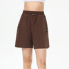 Full-body editorial tennis portrait featuring women’s performance shorts designed for movement and comfort.