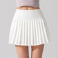 Premium women’s tennis outfit featuring a structured tennis skirt photographed on a tennis court