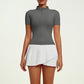Women's refined tennis lifestyle set featuring fitted performance top and pleated skirt, combining elegant silhouette, freedom of movement and premium comfort.