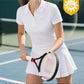 Studio portrait of a woman wearing a premium tennis polo shirt with a tailored fit, combining athletic performance and timeless tennis style.