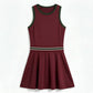 Women's tennis dress with integrated shorts, soft performance fabric, and structured fit designed for movement on court.