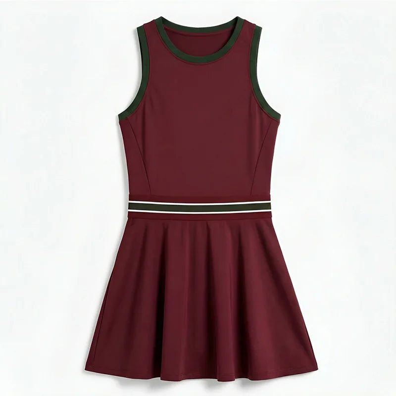 Women's tennis dress with integrated shorts, soft performance fabric, and structured fit designed for movement on court.