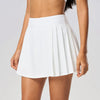 Women's modern tennis skirt photographed on court with refined athletic silhouette and elevated tennis aesthetic
