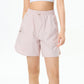 Female athlete wearing premium tennis shorts in a refined editorial sportswear look on court.