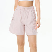 Female athlete wearing premium tennis shorts in a refined editorial sportswear look on court.